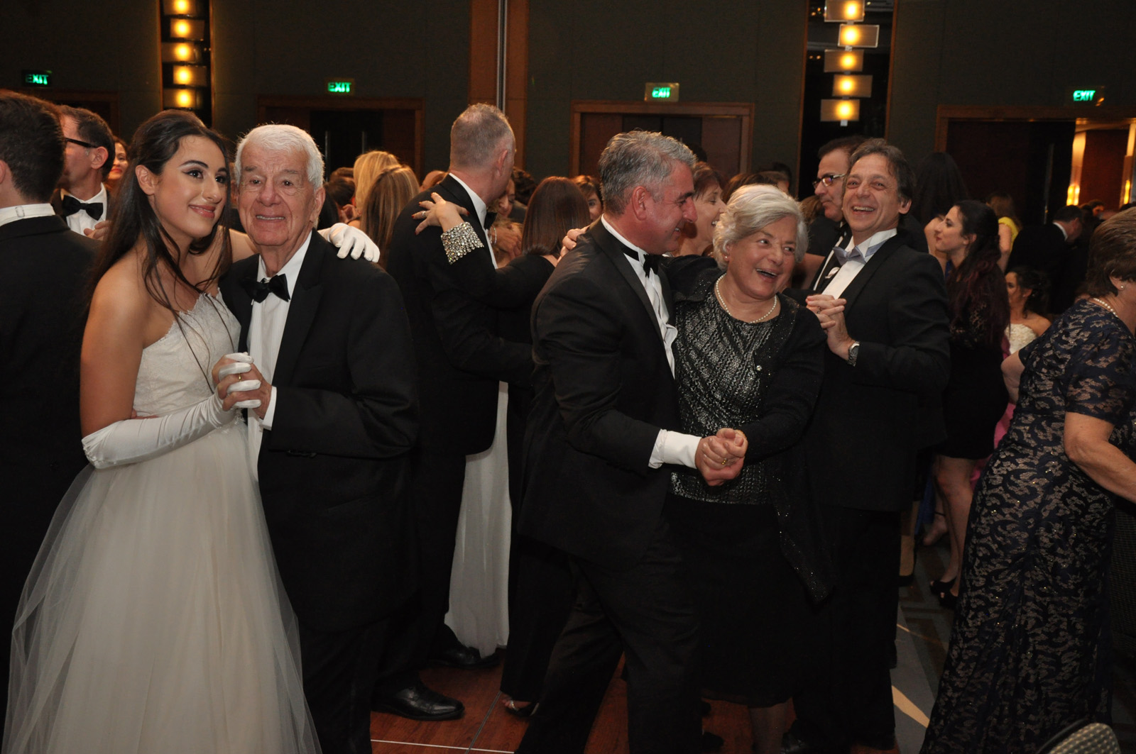 Three generatins of family dancing together at the Greek Debutante Ball, photographed by Kent Johnson Photography, Sydney, Australia.